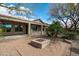 Backyard oasis with desert landscaping, a fire pit, covered patio, and lush greenery at 5723 E Jake Hvn, Cave Creek, AZ 85331