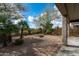 Wide angle shot of a large landscaped backyard, fire pit, patio, and desert foliage at 5723 E Jake Hvn, Cave Creek, AZ 85331