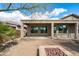 Covered patio area featuring a fire pit and a low maintenance landscaped backyard at 5723 E Jake Hvn, Cave Creek, AZ 85331