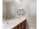 Bright bathroom featuring a double sink vanity with modern fixtures and a large mirror at 5723 E Jake Hvn, Cave Creek, AZ 85331