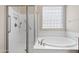 Bathroom with a walk-in shower and a soaking tub with tile surround at 5723 E Jake Hvn, Cave Creek, AZ 85331