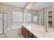 Bathroom featuring a soaking tub, walk-in shower, double sink vanity, and ample natural light at 5723 E Jake Hvn, Cave Creek, AZ 85331