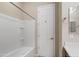 Bathroom featuring a shower-tub combination with white tiled walls, and white storage door at 5723 E Jake Hvn, Cave Creek, AZ 85331