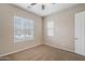 Carpeted bedroom featuring a bright window and a ceiling fan at 5723 E Jake Hvn, Cave Creek, AZ 85331