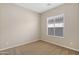 Cozy bedroom showcasing neutral carpet, fresh paint, and a sunlit window with blinds at 5723 E Jake Hvn, Cave Creek, AZ 85331