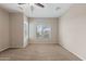 Carpeted bedroom with a ceiling fan and a bright window offering scenic views at 5723 E Jake Hvn, Cave Creek, AZ 85331