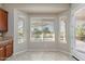 Bright breakfast nook with bay window views, tiled floors, and adjacent kitchen space at 5723 E Jake Hvn, Cave Creek, AZ 85331