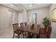 Bright dining room featuring a wood table, seating for six, and a large window with natural light at 5723 E Jake Hvn, Cave Creek, AZ 85331