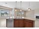 Close-up of kitchen island featuring granite counters, stainless steel dishwasher, and ample storage at 5723 E Jake Hvn, Cave Creek, AZ 85331