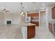Open-concept kitchen with granite island, stainless steel refrigerator, and seamless flow to living area at 5723 E Jake Hvn, Cave Creek, AZ 85331
