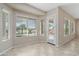 Bright living room features tile flooring, several windows and a door leading to the backyard at 5723 E Jake Hvn, Cave Creek, AZ 85331