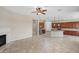 Open floor plan with a fireplace, ceiling fan and spacious kitchen with a large island at 5723 E Jake Hvn, Cave Creek, AZ 85331