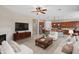 Spacious living room with a fireplace, open layout, and views into the modern kitchen at 5723 E Jake Hvn, Cave Creek, AZ 85331