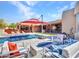 Serene backyard boasts a sparkling pool, lounge chairs, a covered patio, and an outdoor kitchen at 5805 E Agave Pl, Carefree, AZ 85377