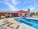 Expansive backyard showcases a refreshing pool, lounge chairs, and a covered outdoor dining area at 5805 E Agave Pl, Carefree, AZ 85377