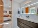 Modern bathroom featuring an illuminated mirror, sleek vanity, and a view into the bedroom at 5805 E Agave Pl, Carefree, AZ 85377