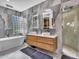 Stunning bathroom features double sink vanity, soaking tub, and glass block window for natural light at 5805 E Agave Pl, Carefree, AZ 85377