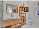Bathroom with floating wood vanity, marble countertop, large mirror, and linen storage at 5805 E Agave Pl, Carefree, AZ 85377