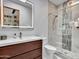 Modern bathroom features a vanity with a vessel sink and frameless shower with decorative stone accent at 5805 E Agave Pl, Carefree, AZ 85377