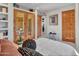 Bright bedroom with white walls, built-in shelves, and a view to the living room at 5805 E Agave Pl, Carefree, AZ 85377
