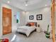 Bright bedroom with white walls, neutral decor, and a wooden door at 5805 E Agave Pl, Carefree, AZ 85377
