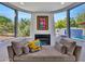 Inviting bedroom nook offers a cozy seating area with fireplace and views of the backyard oasis at 5805 E Agave Pl, Carefree, AZ 85377