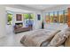 Bright, open bedroom features a seating area and large windows overlooking the backyard pool at 5805 E Agave Pl, Carefree, AZ 85377
