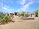 Desert home with three-car garage and natural landscape in the front yard at 5805 E Agave Pl, Carefree, AZ 85377