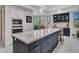 Stylish kitchen island with white marble countertop, bar stool seating, and ample cabinet space at 5805 E Agave Pl, Carefree, AZ 85377
