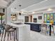 Modern kitchen with white counters, sleek stainless steel appliances, and a center island with bar seating at 5805 E Agave Pl, Carefree, AZ 85377