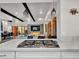 Gourmet kitchen with stainless steel cooktop flows into open concept living and dining area at 5805 E Agave Pl, Carefree, AZ 85377