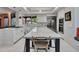 Open concept kitchen featuring a spacious island with bar seating and modern appliances at 5805 E Agave Pl, Carefree, AZ 85377