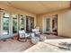 Inviting covered patio with comfortable seating and multiple entrances to the home at 5805 E Agave Pl, Carefree, AZ 85377