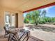 Cozy covered patio featuring chairs and ottomans with scenic views of the yard at 5805 E Agave Pl, Carefree, AZ 85377