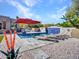 Relaxing backyard pool with waterfall feature, sun loungers, and lush landscaping at 5805 E Agave Pl, Carefree, AZ 85377