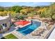 Desert home with beautiful backyard pool, lounge chairs and a waterfall feature at 5805 E Agave Pl, Carefree, AZ 85377