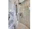 Modern shower with luxurious shower head and gray textured surround tile at 5805 E Agave Pl, Carefree, AZ 85377