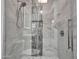 Modern tile shower features decorative stone accent, a built-in niche, and glass door at 5805 E Agave Pl, Carefree, AZ 85377