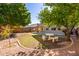 View of the backyard with green grass, desert landscaping, block wall fence, and a concrete picnic table at 6312 W Villa Linda Dr, Glendale, AZ 85310