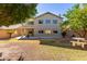 Large backyard showcasing a two story home surrounded by mature trees at 6312 W Villa Linda Dr, Glendale, AZ 85310