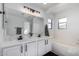 Bright bathroom featuring dual sinks and a soaking tub at 6312 W Villa Linda Dr, Glendale, AZ 85310