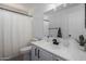 Bright bathroom featuring a sleek vanity, mirror, and shower/tub combo at 6312 W Villa Linda Dr, Glendale, AZ 85310