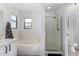 Bright bathroom featuring a glass enclosed shower and a soaking tub at 6312 W Villa Linda Dr, Glendale, AZ 85310