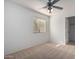 Neutral bedroom featuring a ceiling fan and a window with blinds at 6312 W Villa Linda Dr, Glendale, AZ 85310