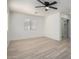 Spacious bedroom has wood-look floors, a ceiling fan, a window, and a closet with mirrored doors at 6312 W Villa Linda Dr, Glendale, AZ 85310