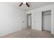 Neutral bedroom featuring a ceiling fan and a sliding door closet at 6312 W Villa Linda Dr, Glendale, AZ 85310