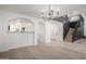 Bright dining area with modern chandelier and view of the kitchen and staircase at 6312 W Villa Linda Dr, Glendale, AZ 85310