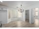 Dining area with bay window, wood-look floors, modern chandelier, and neutral paint, perfect for entertaining at 6312 W Villa Linda Dr, Glendale, AZ 85310