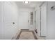 Bright entryway with white walls, tiled flooring, and a mirror by the front door at 6312 W Villa Linda Dr, Glendale, AZ 85310