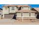 Two-story house with a brown garage door, neutral colored stucco, and desert landscaping at 6312 W Villa Linda Dr, Glendale, AZ 85310